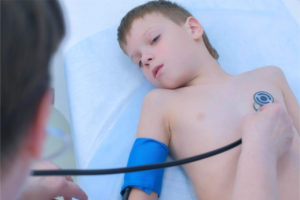 a little boy having an examination for heart condition